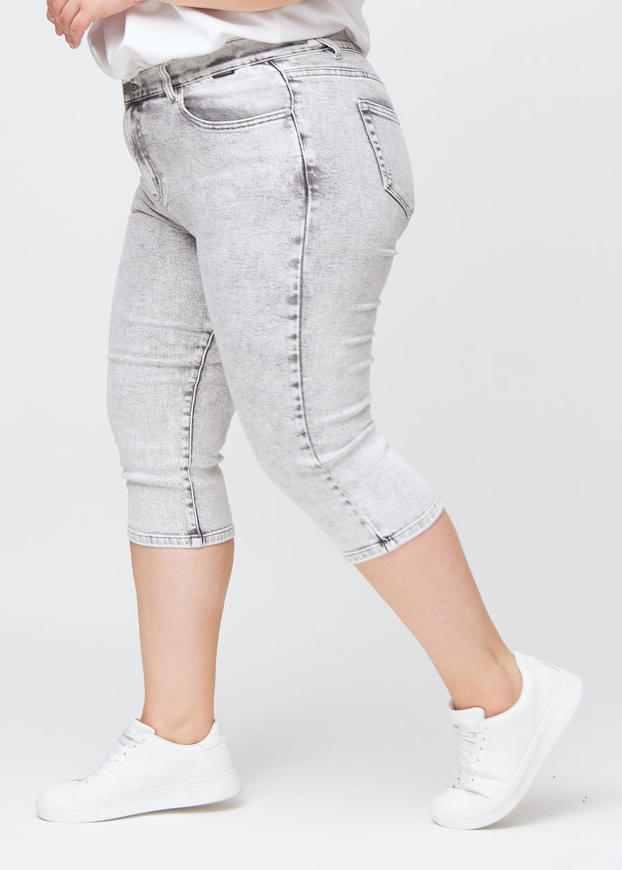 Lysegrå denim slim capris i farven Ashes – set fra siden på en plus-size model, så man ser pasform og silhuet.