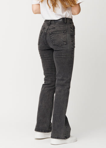 Dark grey mid-rise bootcut jeans in Shadows. Back view on a model, showing the full fit.