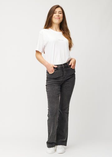 Dark grey mid-rise bootcut jeans in Shadows. Full-length view of a model wearing the jeans.