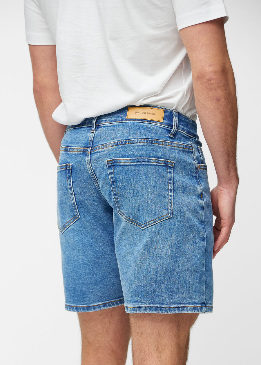 Blue denim shorts for men in the colour Rivers seen from the back close up to show fit and details.
