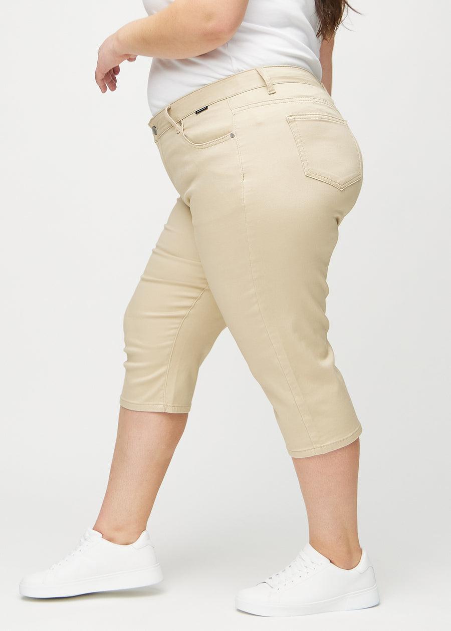 Beige regular capris seen from the side on a plus-size model.