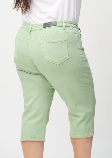 Light green regular capris seen from the back up close on a plus-size model to show details.