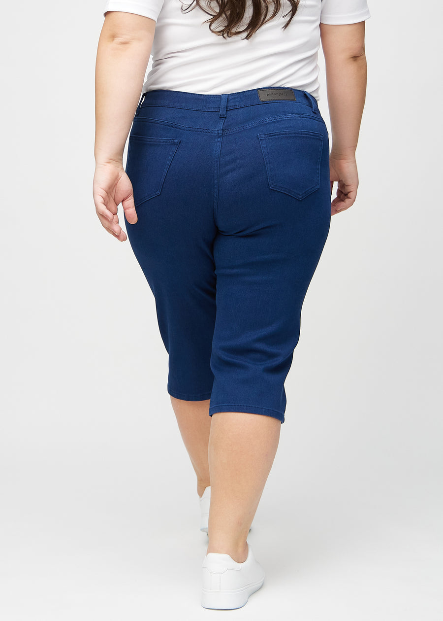 Dark blue regular capris seen from the back on a plus-size model, so the entire product can be seen.