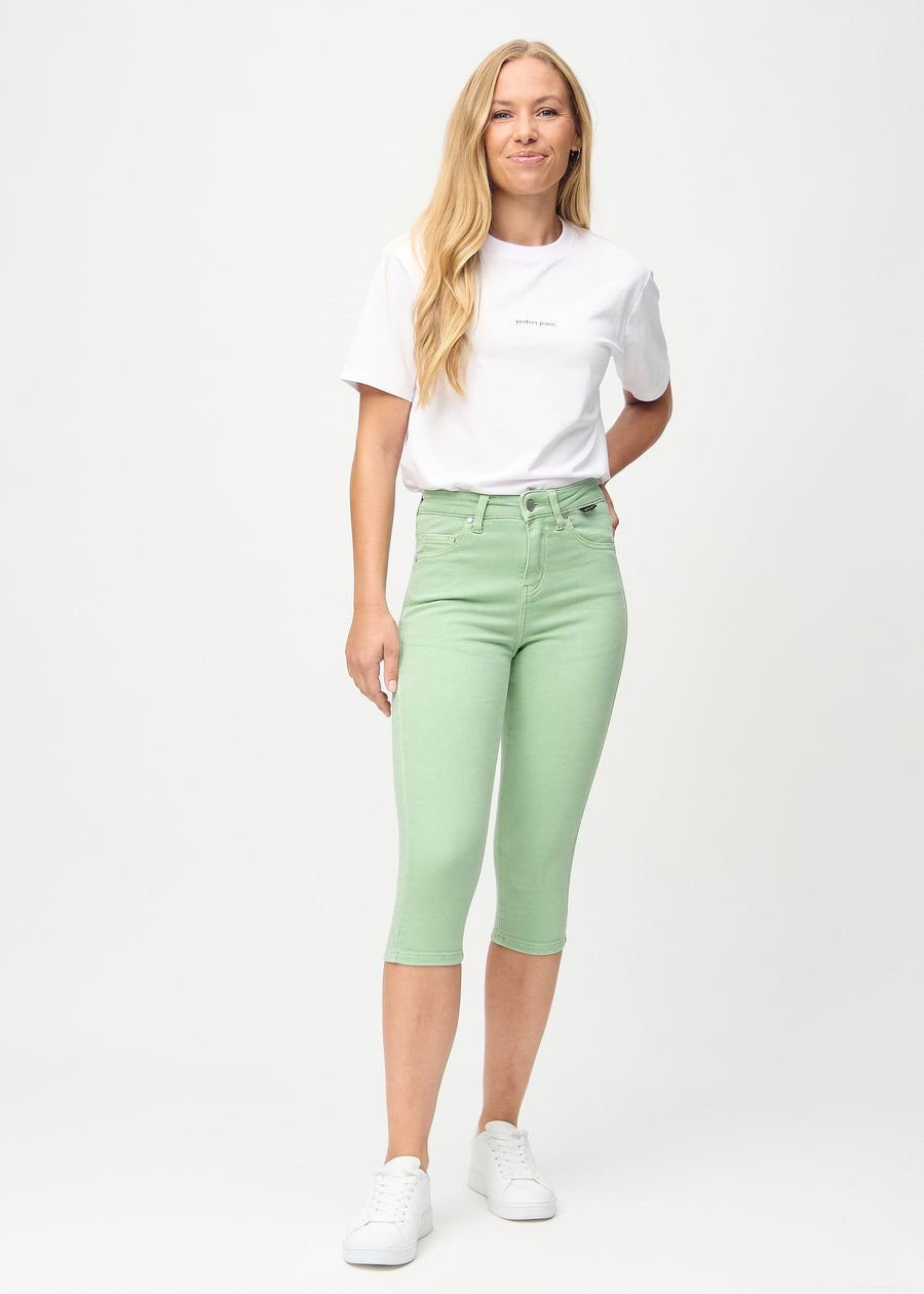Skinny capris for women in pastel green fabric, color Mints. Full-length view of a model wearing the capris.