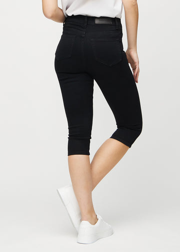 Black skinny capris seen from the back, so the entire product can be seen.