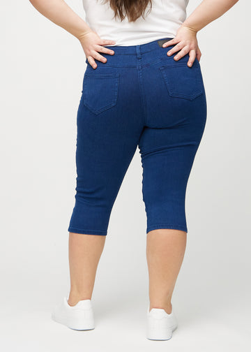 Skinny capris for women in dark blue fabric, color Royals. Back view on a plus-size model, showing the fit and back pockets.