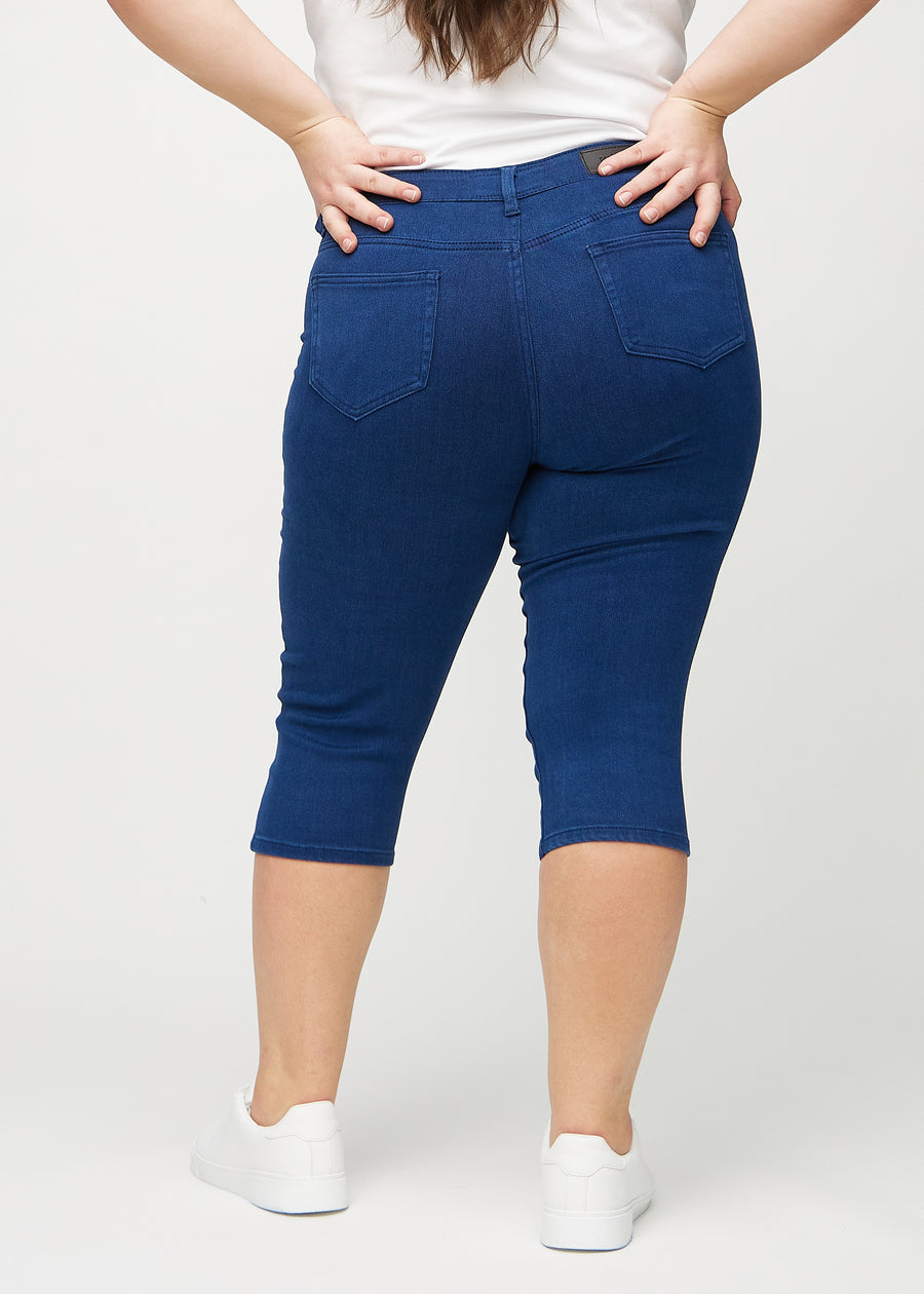 Skinny capris for women in dark blue fabric, color Royals. Back view on a plus-size model, showing the fit and back pockets.