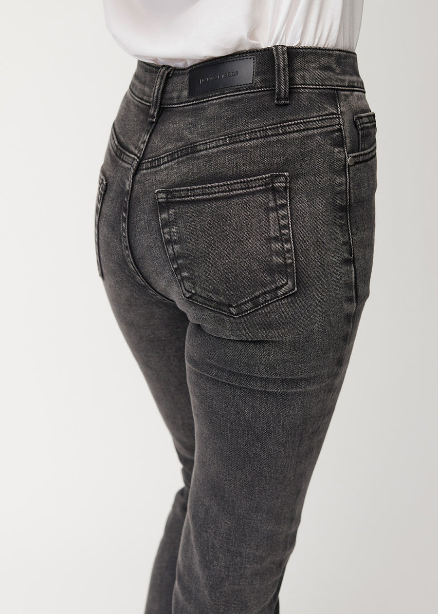 Dark grey mid-rise bootcut jeans in Shadows. Close-up back view on a model, showing the details.
