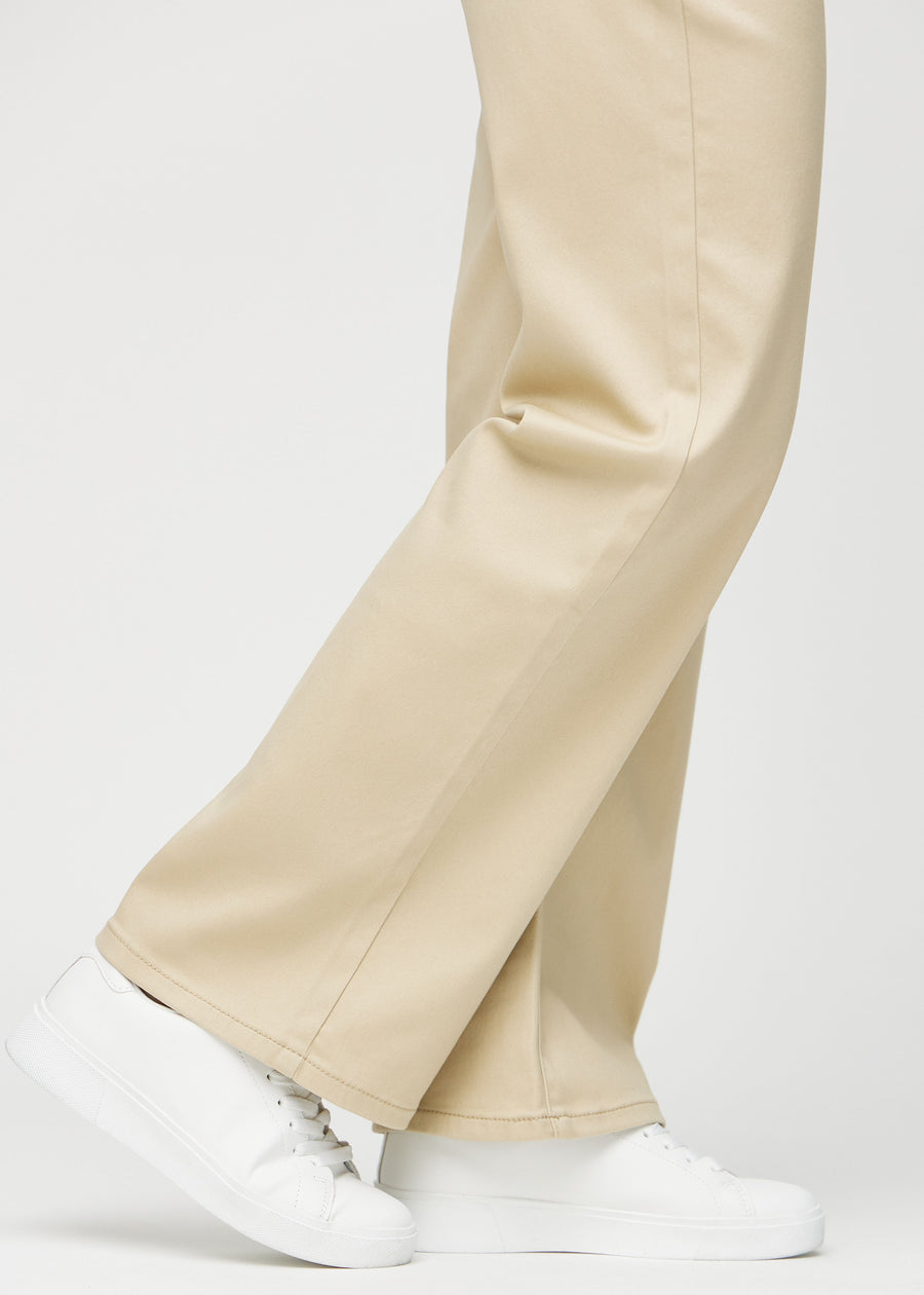Loose jeans for women in beige, color Gazelles. Close-up at the ankles on a model, showing the wide leg openings.
