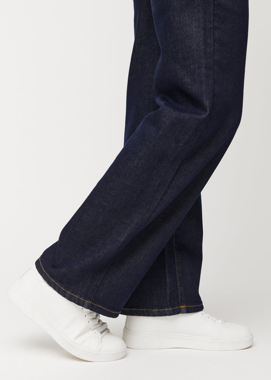Deep dark blue denim jeans for women in the colour Midnights with a loose fit shown close up at the ankles to show the wide finish.