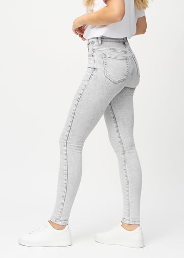 Skinny jeans for women in light grey, color Ashes. Side view on a model.