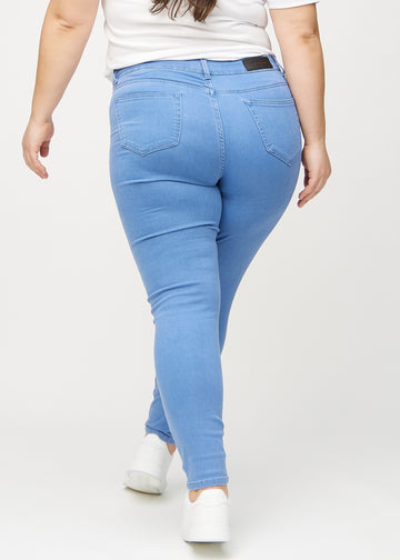 Skinny jeans for women in blue, color Geraniums. Back view on a plus-size model, showing the overall fit.
