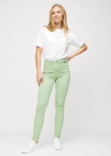 Full image of a model in light green skinny jeans.