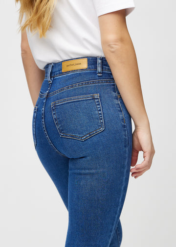Dark denim skinny jeans seen from the back in close-up to show details.