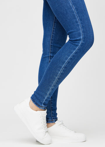 The ankles of a model, so you can see how tightly the jeans fit.