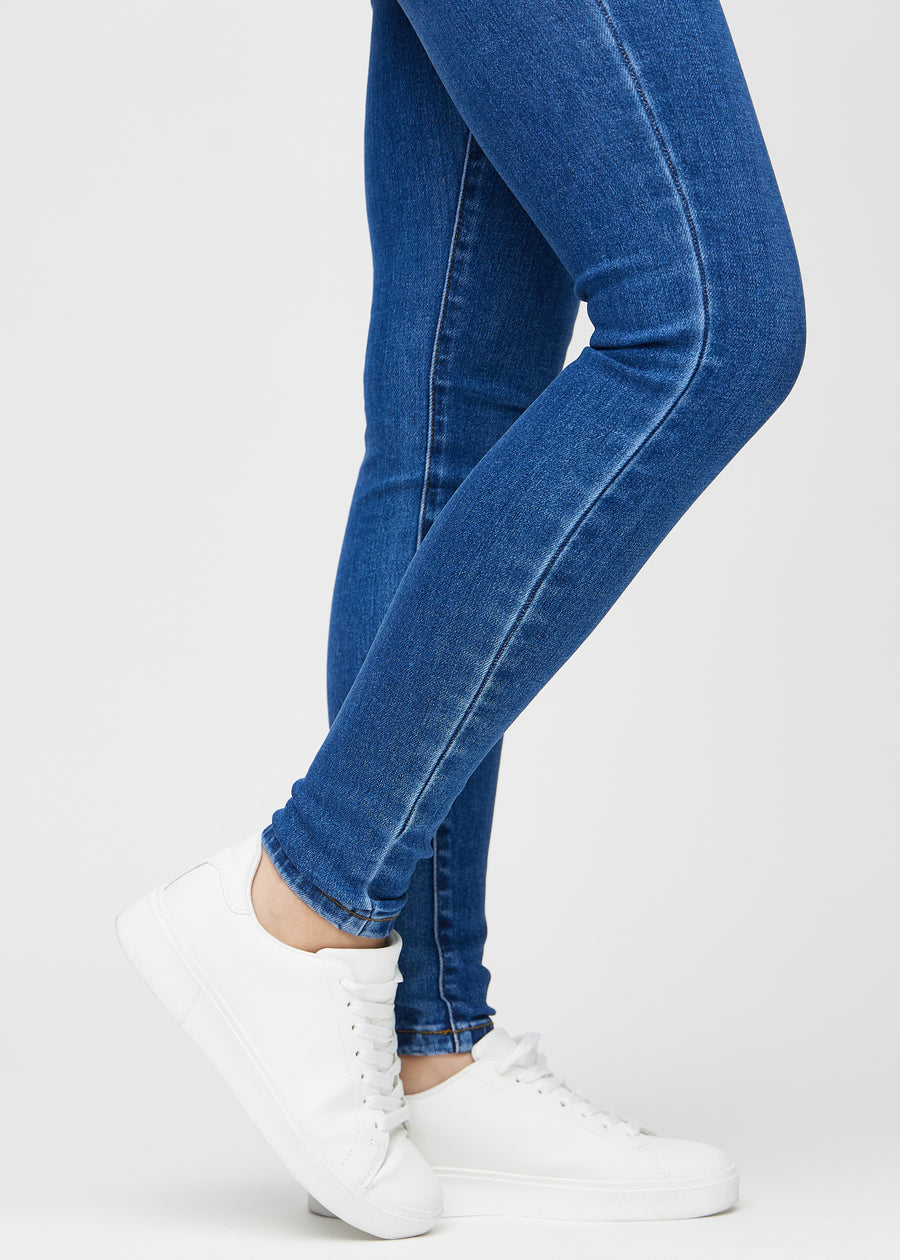 The ankles of a model, so you can see how tightly the jeans fit.
