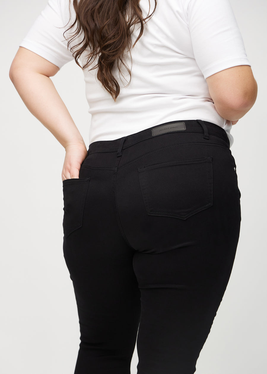 Skinny jeans for women in black, color Ravens. Close-up back view on a plus-size model, showing the details.