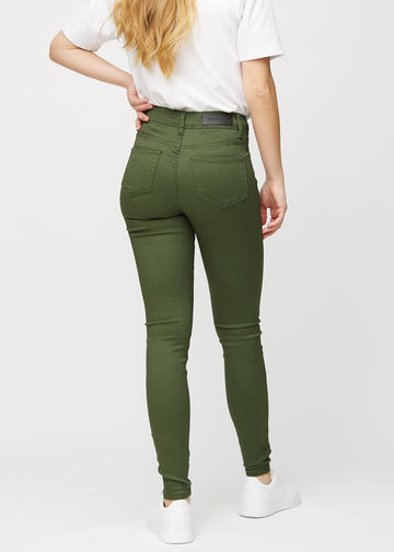Skinny jeans for women in dark green, color Renewals. Back view on a model, showing the overall fit.