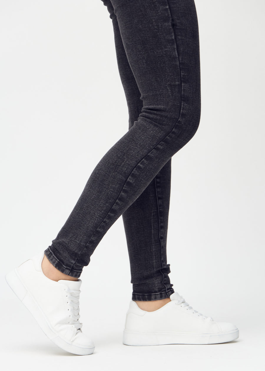 The ankles of a model, so you can see how closely the jeans fit.