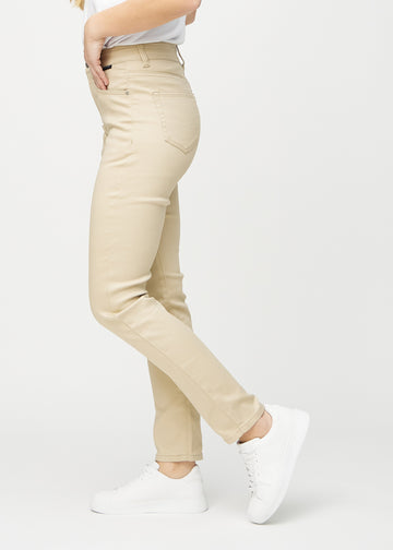 Beige slim jeans seen from the side on a model.