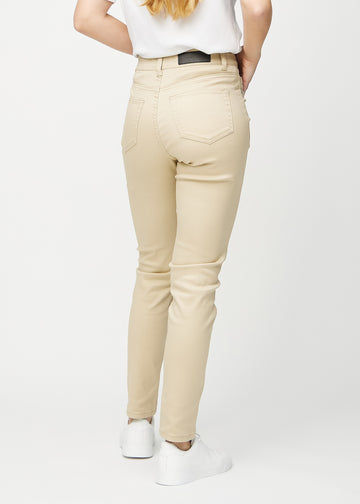 Beige slim jeans seen from behind, so the entire product can be seen.