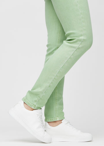 Slim jeans for women in light green, color Mints. Close-up at the ankles on a model, showing the fit at the leg openings.