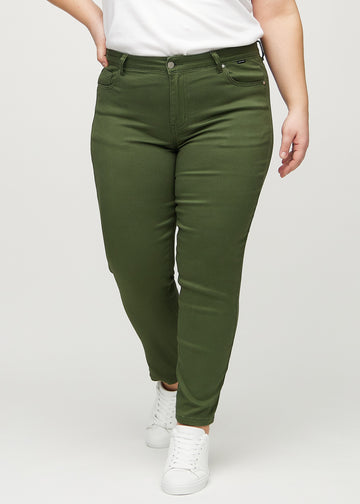 Slim jeans for women in dark green, color Renewals. Front view on a plus-size model, showing a close fit through the leg with a little more room at the ankle.