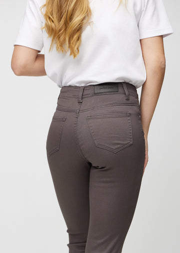Slim jeans for women in grey-brown, color Thunders. Close-up back view on a model, showing the details.