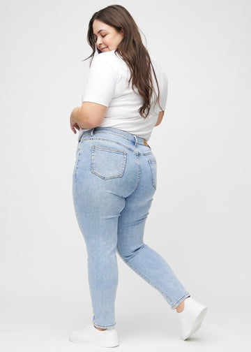 Slim jeans for women in light blue, color Waves. Side view on a plus-size model.