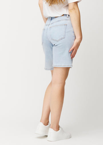 Lyseblå denimshorts til kvinder i farven Waves set bagfra, så den løse pasform kan ses.