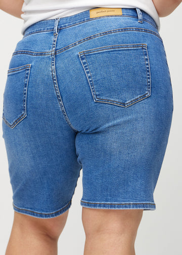 Denim regular middle shorts seen from the back close up on a plus-size model to show details.