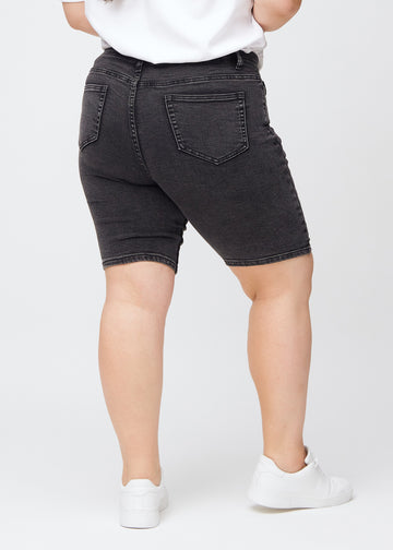 Woman in dark grey denim shorts seen from the back