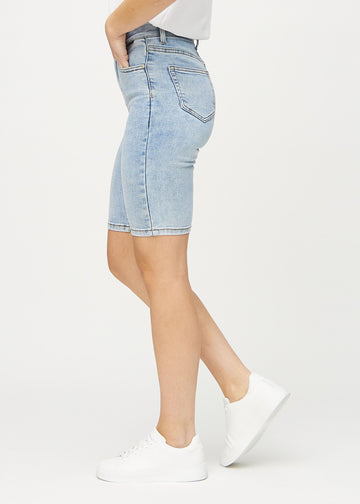 Light denim skinny middle shorts seen from the side on a model.