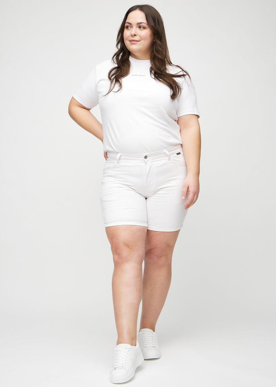 Full image of a plus-size model wearing white skinny short shorts.