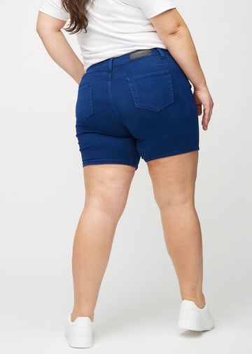 Dark blue skinny short shorts seen from the back on a plus-size model, so the entire product can be seen.