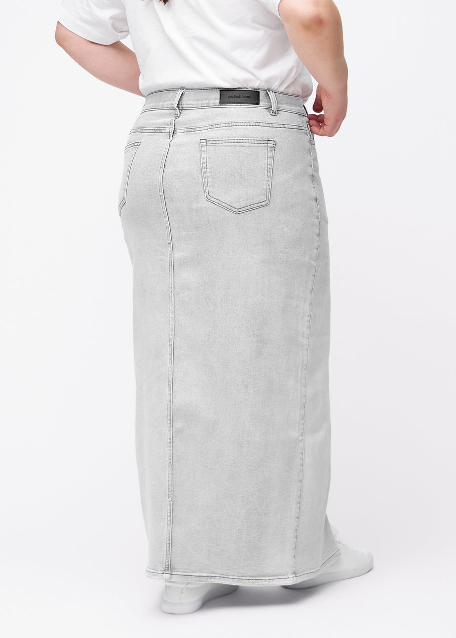 Long light grey denim skirt for women in the color Ashes. Back view on a plus-size model, showing the full length of the skirt.
