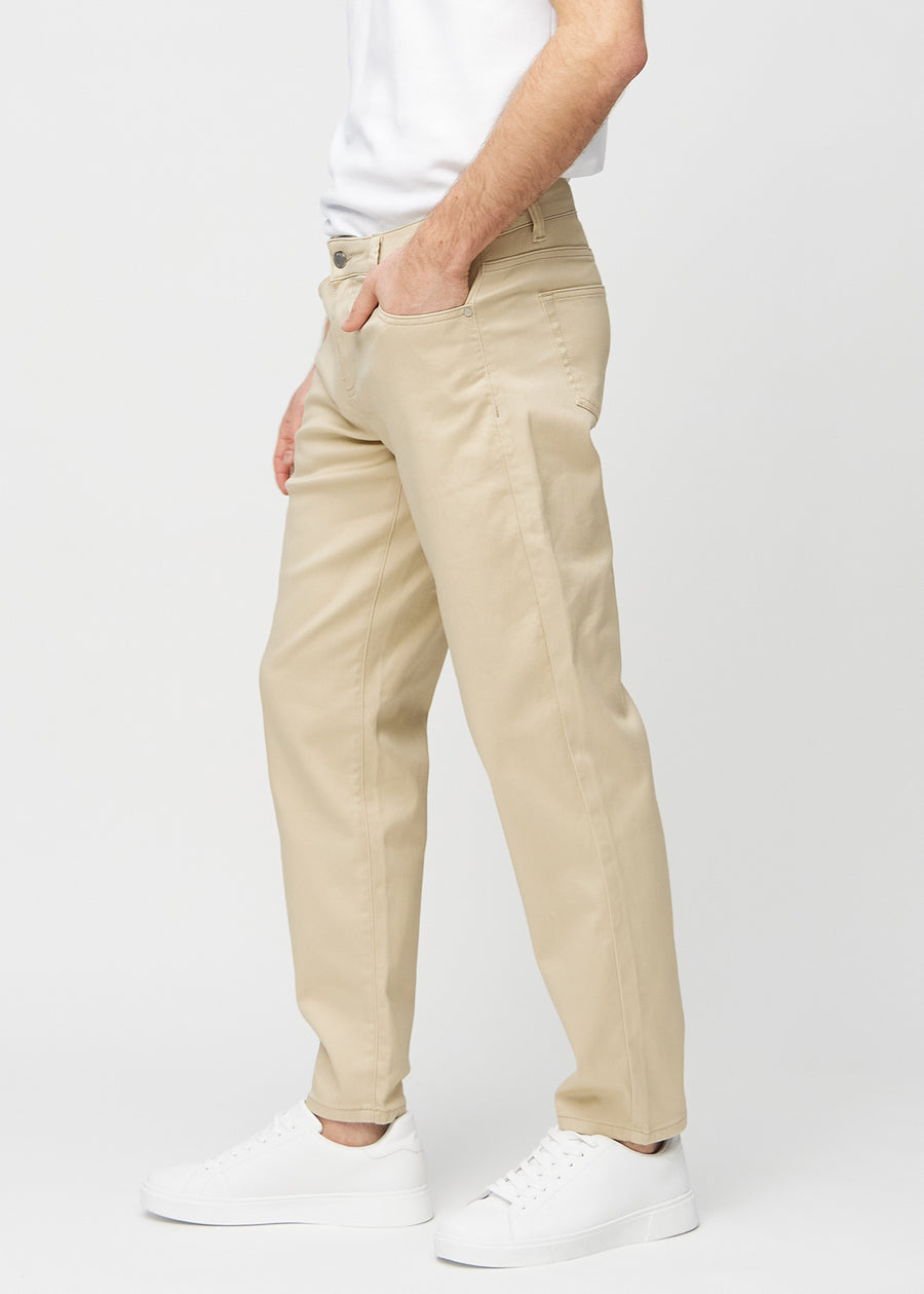 Beige regular jeans seen from the side on a model.