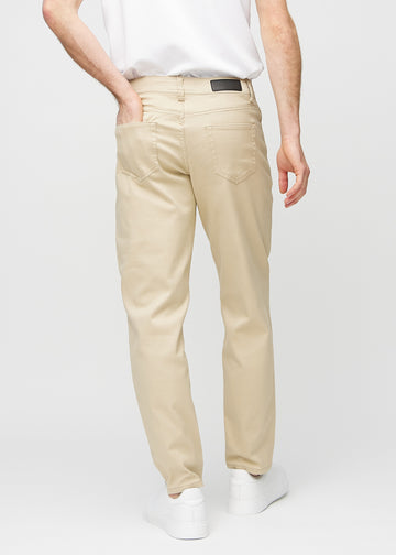 Beige regular jeans seen from the back, so the entire product can be seen.