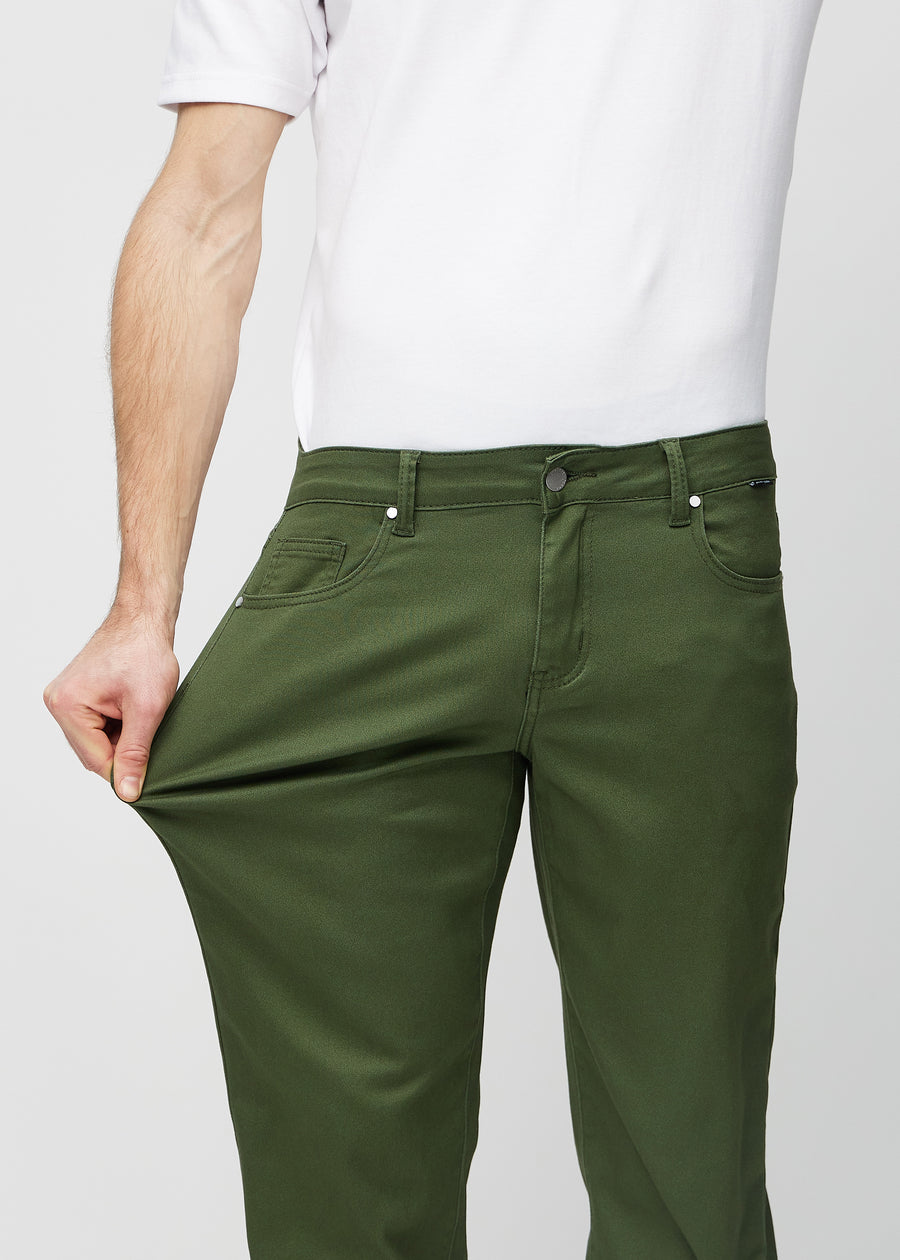 The model stretches the jeans at the thigh to show the stretch.