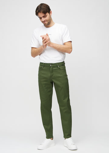 Full image of a model in dark green regular jeans.