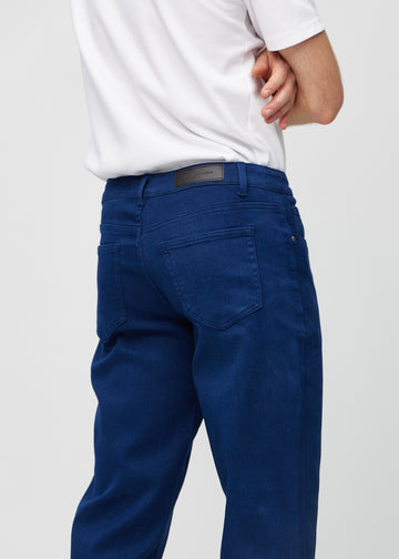 Dark blue regular jeans seen from the back close up to show details.