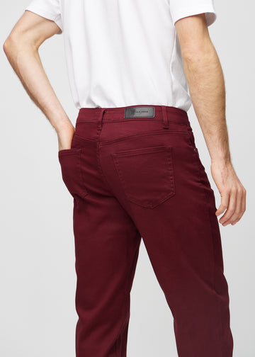 Dark red regular jeans seen from the back close up to show details.