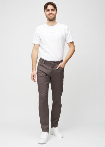 Full image of model in grey-brown regular jeans.