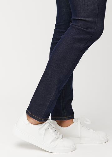 Close-up of the ankles in deep dark blue Midnights slim denim jeans for men, showing the narrow leg opening.
