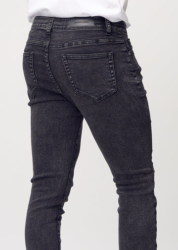 Close-up back view of dark grey denim slim jeans showing details.