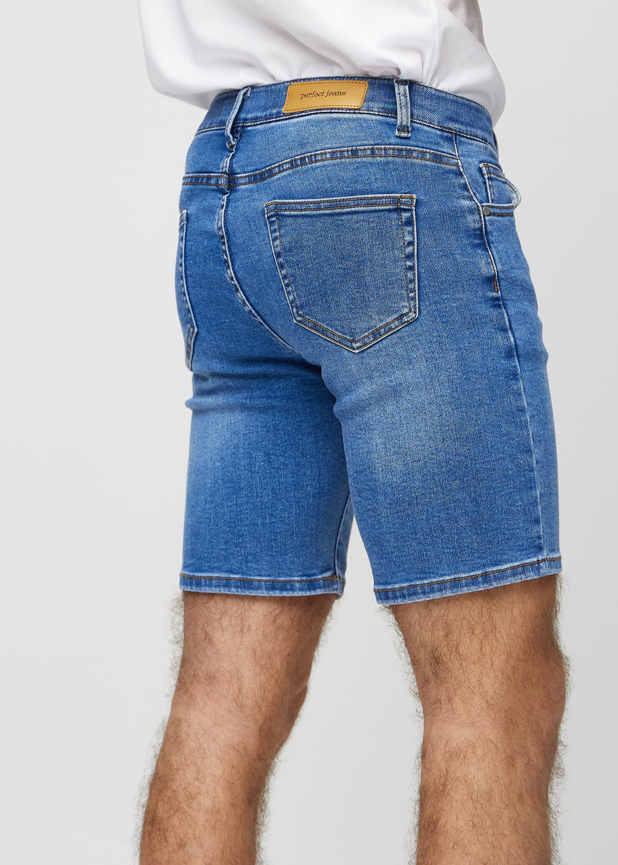 Denim middle-slim shorts seen from the back close up to show details.