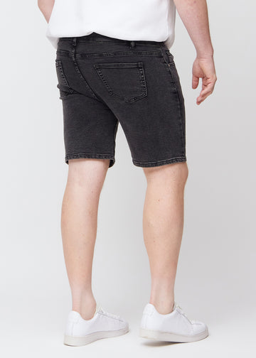Dark grey denim middle-slim shorts seen from the back on a plus-size model, so the entire product can be seen.
